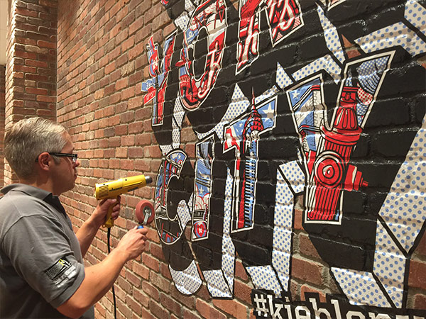 Vinyl graphics installation on brick wall